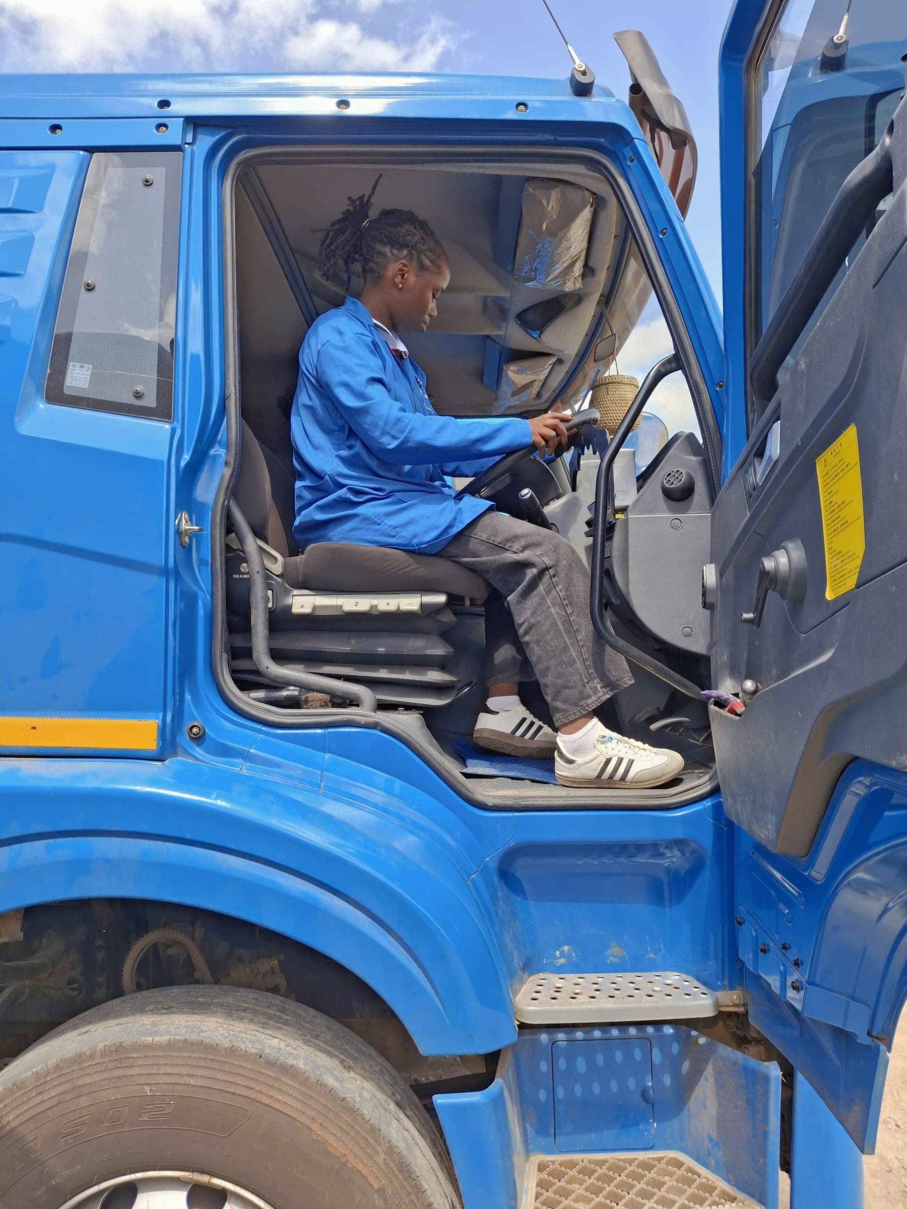 Shenitech technician in blue uniform installing electronics in commercial truck cab