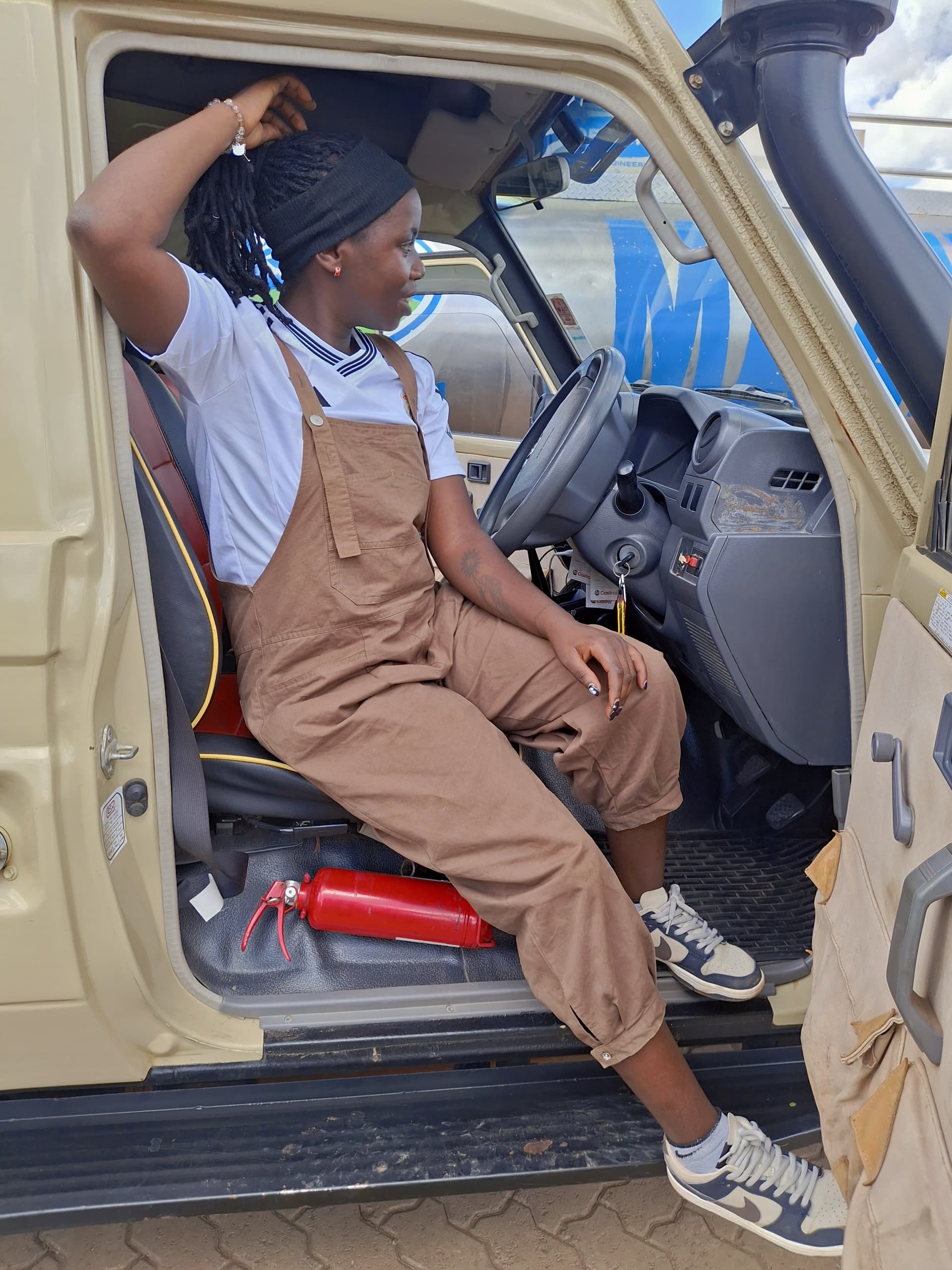 Technician seated in vehicle cab during electronics service