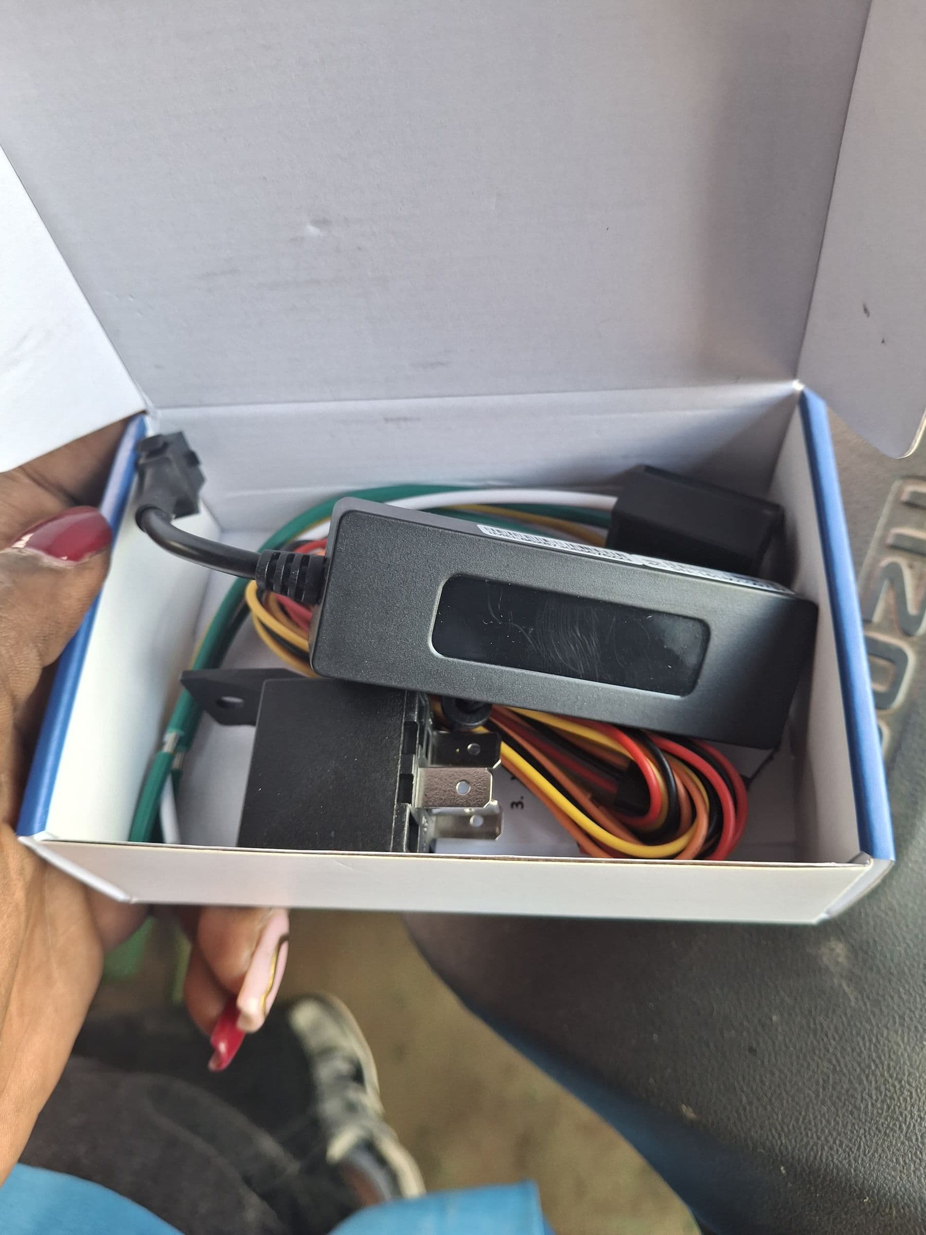 GPS vehicle tracker unit with multicoloured wiring harness ready for installation